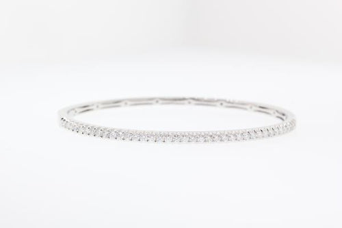 14k white gold diamond bangle bracelet with round brilliant cut diamonds weighing .99 carats total of F color, VS2 clarity.