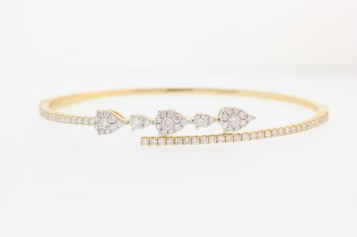18k yellow gold diamond cuff bangle bracelet with round brilliant cut diamonds weighing 1.24 carats total of F color, VS2 clarity.