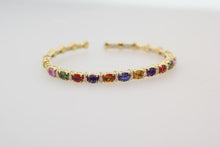 Load image into Gallery viewer, 18k yellow gold diamond and multi-colored sapphire bangle bracelet with multi-colored sapphires weighing 4.95 carats total of excellent cut, hue, and even color distribution. Bangle also features round brilliant cut diamonds weighing .42 carats total of F color, VS2 clarity.
