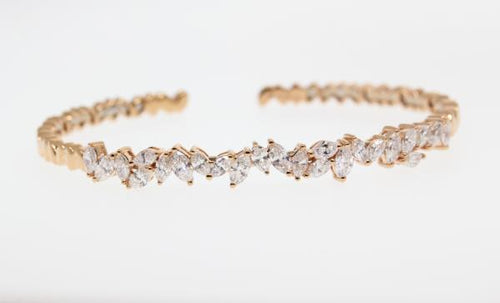 18k rose gold diamond diamond bangle bracelet with marquise cut diamonds weighing 1.97 carats total of G color, VS2 clarity.