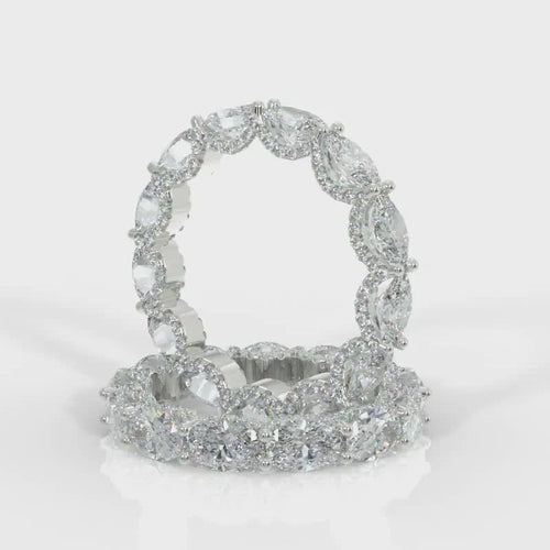 Gorgeous oval eternity band featuring oval brilliant cut diamonds and round brilliant cut diamonds weighing 5.40 carats total of F color, VS2 clarity.