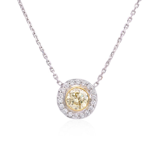 18k white gold diamond pendant necklace. Halo is surrounded by round brilliant cut diamonds weighing 1.05 carats of G color, SI clarity.  Center diamond is an EGL certified fancy light yellow, round brilliant cut.  Necklace measures 16