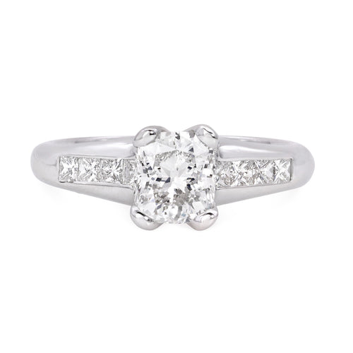 Platinum diamond engagement ring featuring 8 princess cut diamonds weighing .34 carats of G color, SI clarity.  Center diamond is a GIA certified cushion cut weighing 1.06 carats of G color, SI1 clarity.