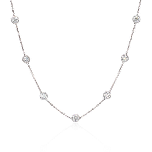 One handmade 18k white gold diamond necklace featuring round brilliant cut diamonds weighing 6.76 carats total of F color, VS2 clarity, and of excellent cut and brilliance. 
