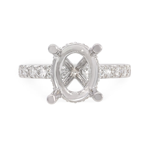 Handmade 18k white gold diamond engagement ring setting featuring round brilliant cut diamonds weighing .90  carats total of F color, VS2 clarity, and of excellent cut and brilliance.