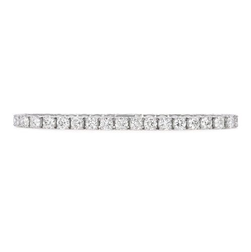 One handmade 14k white gold diamond tennis bracelet features 37 round brilliant cut diamonds weighing 12.12 carats total of G color, VS2 clarity, and of excellent cut and brilliance.