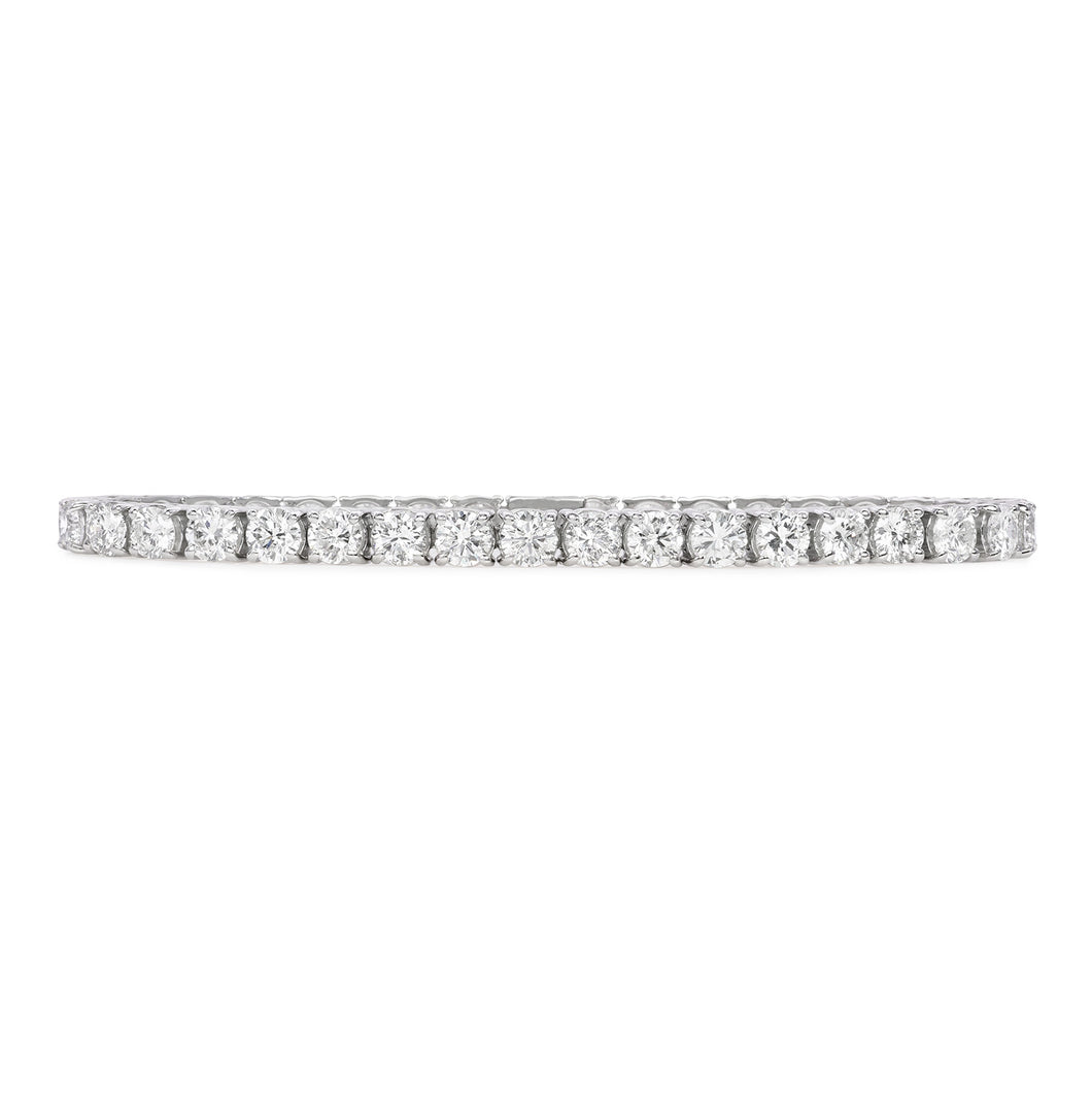 One handmade 14k white gold diamond tennis bracelet features 37 round brilliant cut diamonds weighing 12.12 carats total of G color, VS2 clarity, and of excellent cut and brilliance.