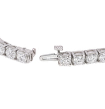 Load image into Gallery viewer, One handmade 14k white gold diamond tennis bracelet features 37 round brilliant cut diamonds weighing 12.12 carats total of G color, VS2 clarity, and of excellent cut and brilliance.
