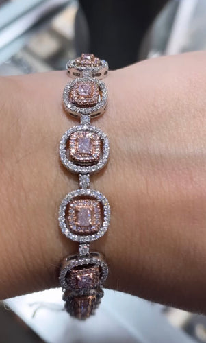 Natural light pink diamond bracelet  Set in 18k two-tone White and rose gold      4.66 Carat Total Weight     2.45 Carat Light Pink Cushions      2.22 Carat White Round Diamonds